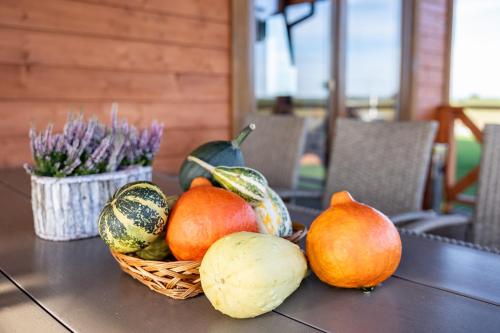 a table with a basket of fruits and vegetables on it at BANIA NA CZASIE in Szyldak