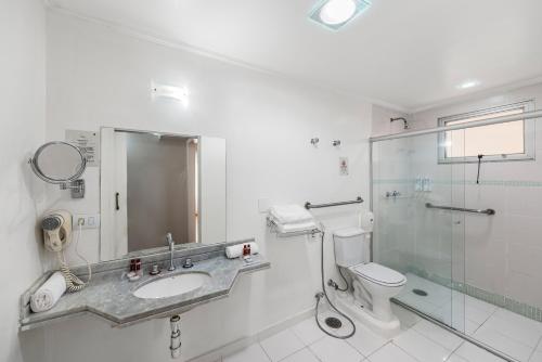 a bathroom with a sink and a toilet and a shower at Capcana Hotel Jardins in Sao Paulo
