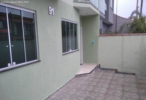 a building with a door and a brick walkway outside at Casa Cidade Nova, Jd Belvedere. in Volta Redonda