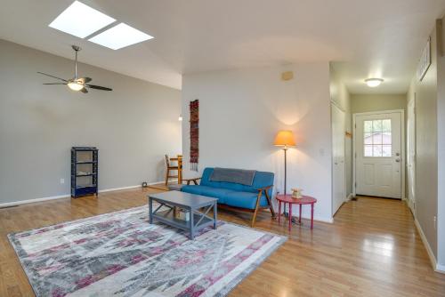 a living room with a blue couch and a table at Pet-Friendly Anchorage Home - 8 Mi to Downtown! in Anchorage