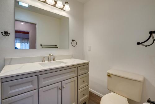 a bathroom with a sink and a toilet and a mirror at Pet-Friendly Anchorage Home - 8 Mi to Downtown! in Anchorage
