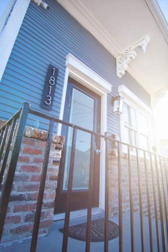 a front door of a blue house with a balcony at Treme Treasure in New Orleans