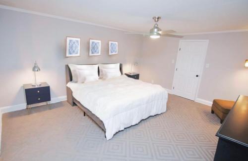 a bedroom with a large white bed and a couch at Treme Treasure in New Orleans