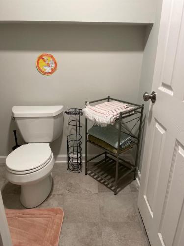 a bathroom with a toilet and a towel rack at My little place in Stratford