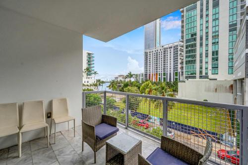 a balcony with chairs and a view of a city at Subtle 2 Bed in Edgewater near Downtown With Free Parking in Miami