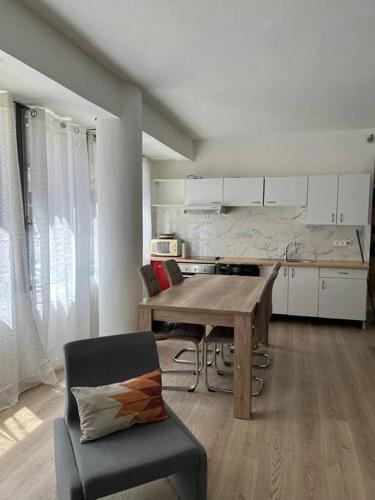 a kitchen with a wooden table and a dining room at Le building: 5 pax centre ville in Marseille