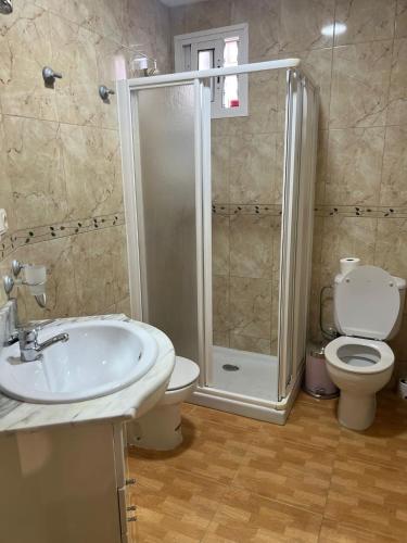 a bathroom with a shower and a sink and a toilet at Guadalora in Lora del Río
