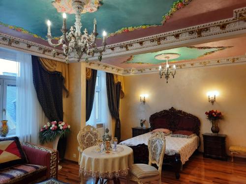 a bedroom with a bed and a chandelier at Fantasy in Karlovy Vary
