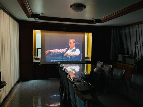 a man on a projection screen in a room at Private rooms in Phatumwan Chula near Samyan, Chinatown, Jay-o Siam center, Central world middle of Bangkok in Bangkok