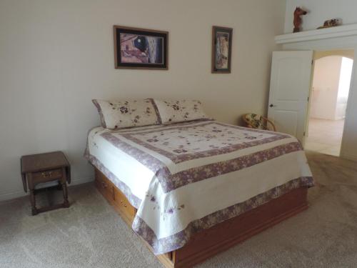 a bedroom with a bed and a night stand next to it at Alibi-Step to open desert in Lake Havasu City