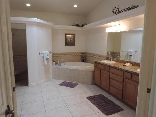 uma casa de banho com uma banheira e um lavatório e uma banheira em Alibi-Step to open desert em Lake Havasu City