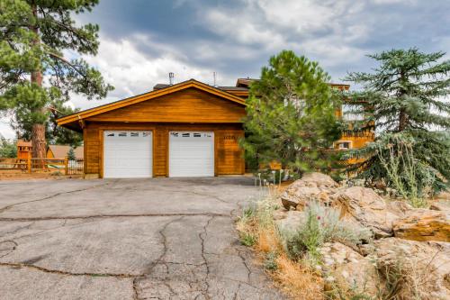 a house with two garage doors on a driveway at The Modern Moose Lodge in Truckee