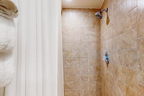 a bathroom with a shower with a shower curtain at Enclave 2202 in Orlando
