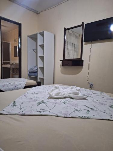 a bedroom with a bed and a mirror on the wall at Center Hotel in Imbé