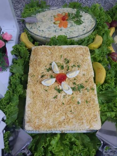 a display of noodles and vegetables on a table at Center Hotel in Imbé