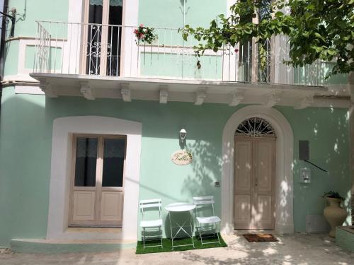 a building with two chairs and a table next to a door at Tullia -intera casa- in Giuliano Teatino