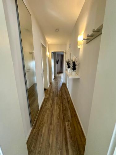 a hallway with a wooden floor and a mirror at St.Barbara Trier in Trier