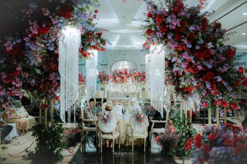 a group of people sitting at a table with flowers at Crowne Plaza Bandung by IHG in Bandung