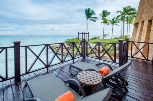a balcony with a table and chairs and the ocean at Sanctuary Cap Cana, a Luxury Collection Resort, Dominican Republic, Adult All-Inclusive in Punta Cana