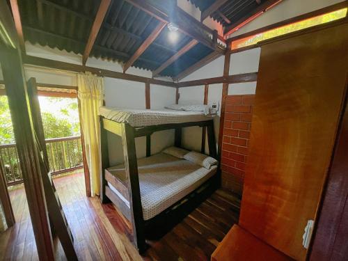 a small room with two bunk beds in it at Hostería El Sendero - Cocorná in Cocorná