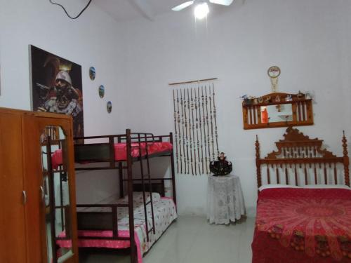 a bedroom with two bunk beds and a bed at Amalfi's Place in Pimentel