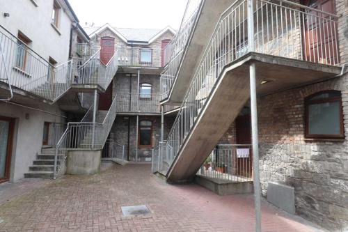 a brick building with stairs on the side of it at Barrow mews views in Carlow