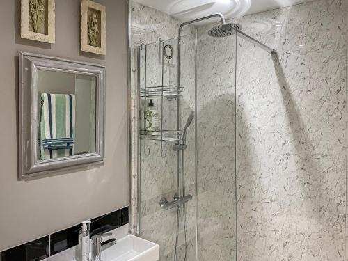 a bathroom with a shower and a sink at Acorn Cottage in Linton