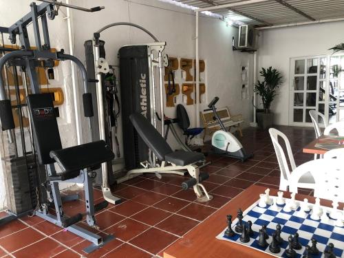 a room with a gym with tread machines and a table at Martinica Hostel in Cartagena de Indias