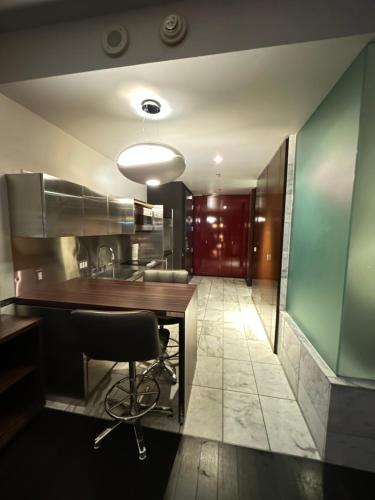 a kitchen with a wooden table and a chair at Amazing view 18th floor at Palms place Las Vegas in Las Vegas