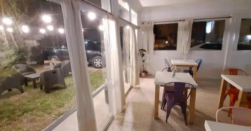 a room with a table and a view of a car at Hotel Kelman in Perito Moreno