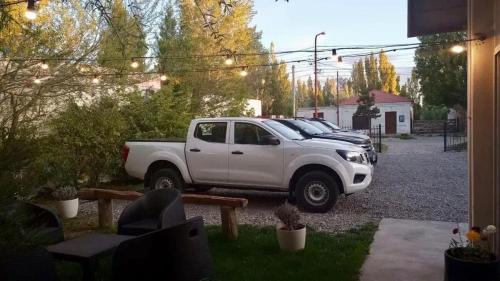 a white pickup truck parked in a driveway at Hotel Kelman in Perito Moreno