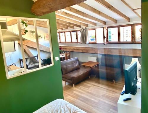 un salon avec un canapé et une télévision dans l'établissement Rétro chic au coeur de Villeurbanne, à Villeurbanne