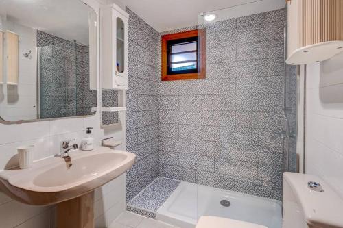 a bathroom with a sink and a toilet and a shower at Compostella Beach - 2 bedroom in Arona