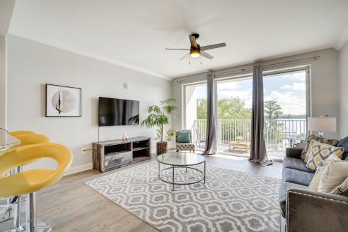 a living room with a couch and a table at 1 Mi to Disney World Lakefront Condo in Orlando! in Orlando