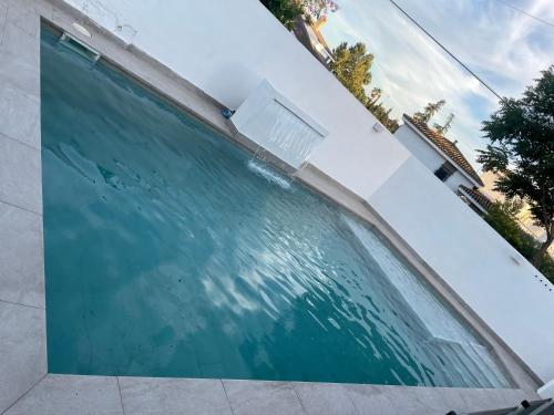 a swimming pool in a building with water at MEDITERRANEAN HOUSE - Habitaciones Privadas en Casa Compartida in Mairena del Aljarafe