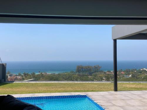 a swimming pool with a view of the ocean at Seaview Sanctuary in Durban