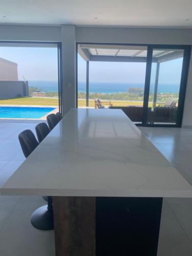 a white table in a room with a view of the ocean at Seaview Sanctuary in Durban
