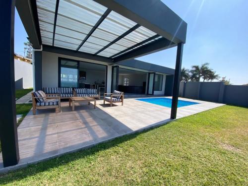 a covered patio with two chairs and a table at Seaview Sanctuary in Durban