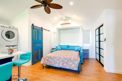 a bedroom with a blue bed and a ceiling fan at Sleek Woodland Hills Retreat with Shared Pool and Yard in Woodland Hills
