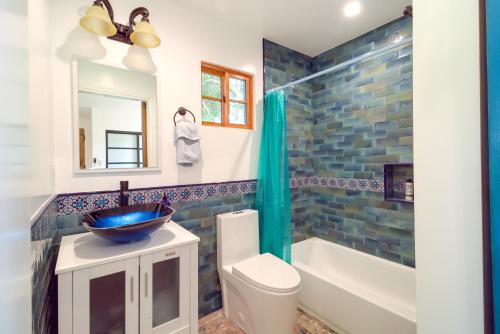 a bathroom with a sink and a toilet and a tub at Sleek Woodland Hills Retreat with Shared Pool and Yard in Woodland Hills