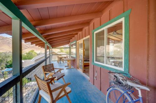 a porch with chairs and a bike on a house at Scenic Kernville Getaway with Deck and Mountain Views! in Kernville