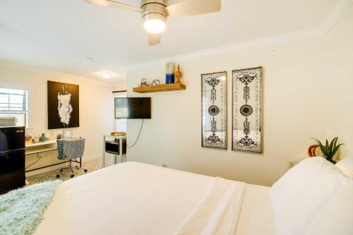 a bedroom with a white bed and a desk at Cozy Houston Studio with Pool Access! in Houston