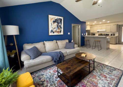 a living room with a white couch and a blue wall at Chic, Quiet 2BR 2BA Near Shops & Restos! in McAllen