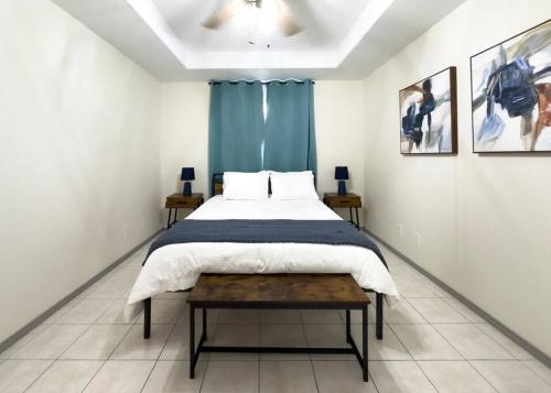 a bedroom with a large bed and a table at Chic, Quiet 2BR 2BA Near Shops & Restos! in McAllen
