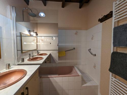 a bathroom with two sinks and a bath tub at Gîte familial près de Nohant avec jardin, cheminée, garage et WIFI gratuit - FR-1-591-94 in Nohant-Vic