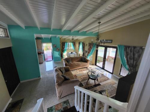 a living room with a couch and a table at A&D Tennis Villa in Arnos Vale