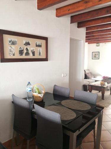 a dining room with a black table and chairs at Casa do Suberco in Nazaré