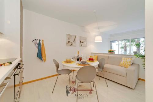 a living room with a table and chairs and a couch at Soleil 5 Apt with Green Terrace in Lugano Center -By EasyLife Swiss in Lugano