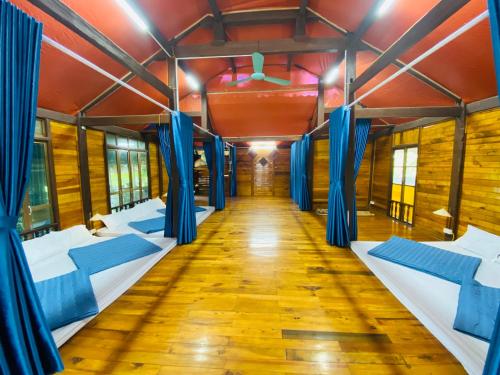 a room with blue curtains and beds in it at Homestay Chinh Bi in Yên Bái
