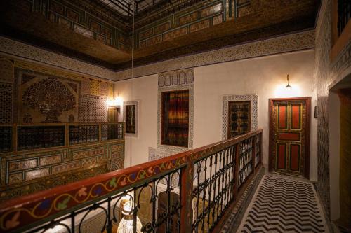 a hallway with a staircase and a door at Riad Qamar Fez in Fès